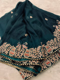 Bottle green Organza Saree with magenta peacock stitched blouse