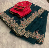 Bottle green Organza Saree with magenta peacock stitched blouse
